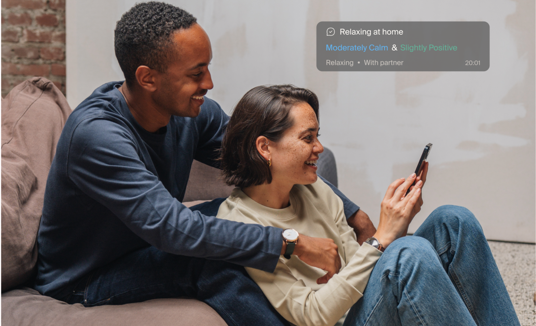 A smiling couple looking at a phone